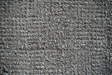 Texture of an old cracked concrete wall. Background image of a worn gray concrete surface