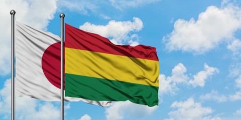 Japan and Bolivia flag waving in the wind against white cloudy blue sky together. Diplomacy concept, international relations.