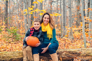 A portrait of a mother with child in the autumn park