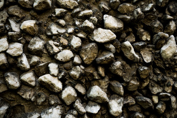 Texture photo of rough concrete plaster with sprinkled gravel