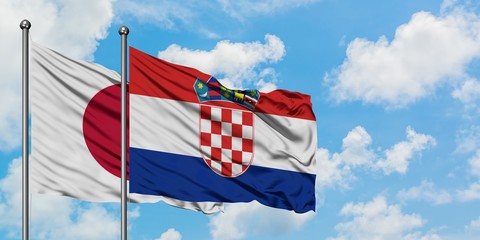 Japan and Croatia flag waving in the wind against white cloudy blue sky together. Diplomacy concept, international relations.