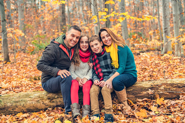 A portrait of a young family in the autumn park