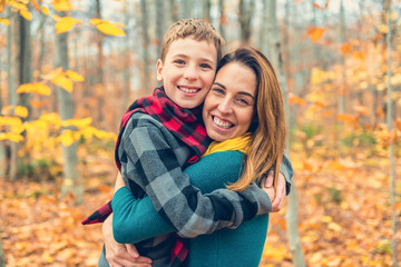 Fototapeta premium A portrait of a mother with child in the autumn park