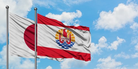 Japan and French Polynesia flag waving in the wind against white cloudy blue sky together. Diplomacy concept, international relations.