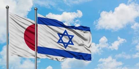 Japan and Israel flag waving in the wind against white cloudy blue sky together. Diplomacy concept, international relations.