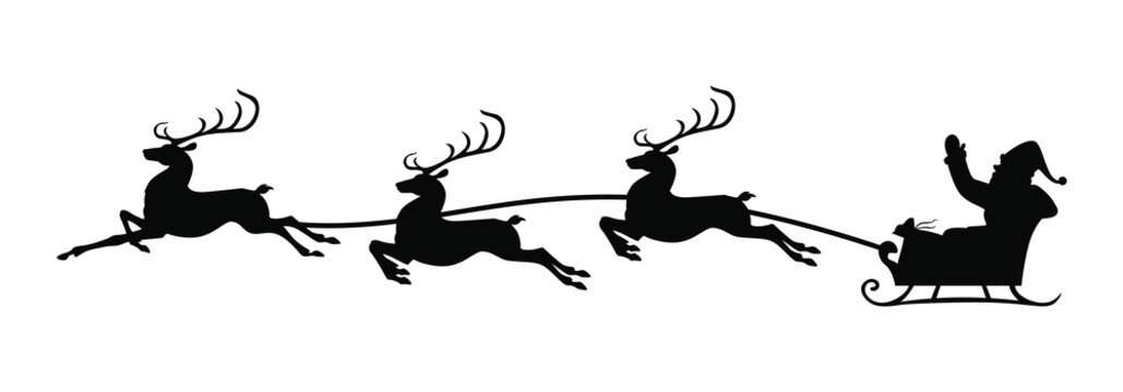 Silhouette Santa riding on reindeer sleigh
