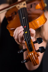 Close up of professional violin in hands of little violinist playing it