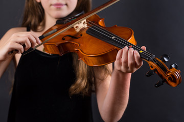 Close up of professional violin in hands of little violinist playing it