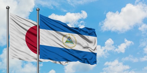 Japan and Nicaragua flag waving in the wind against white cloudy blue sky together. Diplomacy concept, international relations.