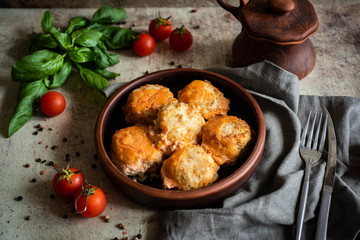 Meat meatballs in a clay plate on a gray background