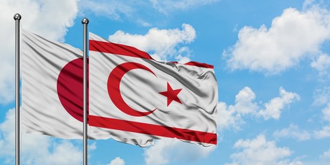 Japan and Northern Cyprus flag waving in the wind against white cloudy blue sky together. Diplomacy concept, international relations.