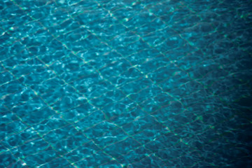 A blue water background. Pool or sea surface texture