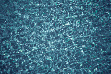 A blue water background. Pool or sea surface texture