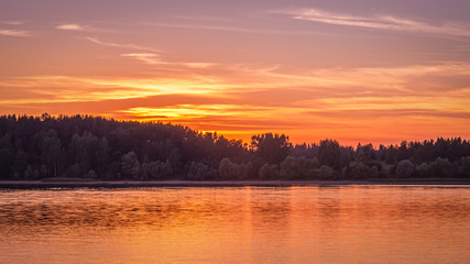 sunset on the forest lake golden hour