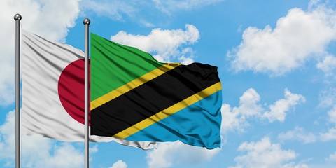 Japan and Tanzania flag waving in the wind against white cloudy blue sky together. Diplomacy concept, international relations.