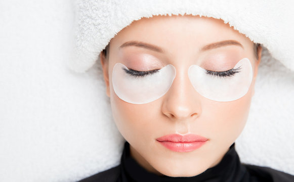 Macro photo woman with long lashes in beauty salon. Concept eyelash extension procedure