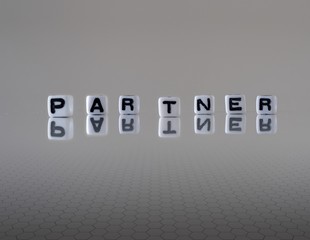 The concept of partner represented by wooden letter tiles