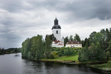 An old church lying next to a river in northern sweden