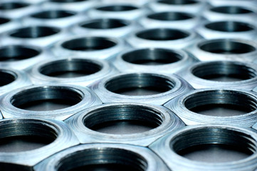 Side view close-up chrome metal nuts