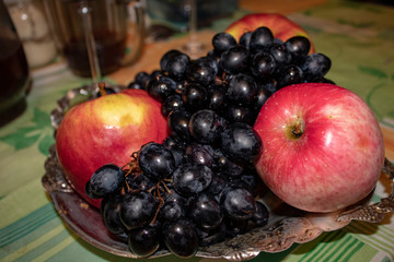 Naklejka na ściany i meble Black sweet grapes and dessert apples are delicious and healthy for the whole family.