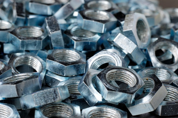 Side view close-up chrome metal nuts
