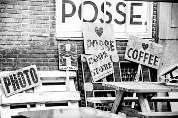 Headings on wooden holdings on the side of a brick wall and wooden bench