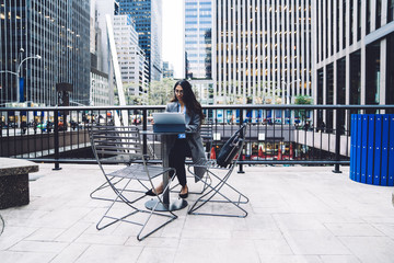 Ethnic woman working on tablet on New York city background