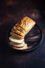 On a round wooden stand is a lean cupcake, a veggie raisin cupcake. Dark background