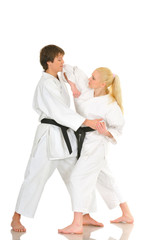 Cute blonde girl and a young cheeky guy karate