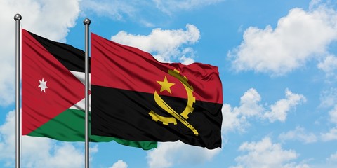 Jordan and Angola flag waving in the wind against white cloudy blue sky together. Diplomacy concept, international relations.