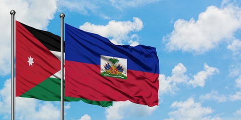 Jordan and Haiti flag waving in the wind against white cloudy blue sky together. Diplomacy concept, international relations.