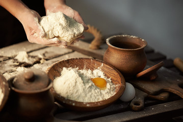Fototapeta na wymiar Woman hands kneads dough from flour