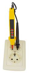 Electrician testing for electricity with a voltage tester