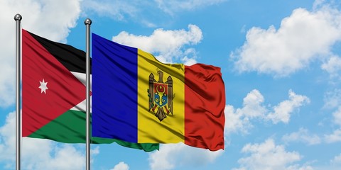 Jordan and Moldova flag waving in the wind against white cloudy blue sky together. Diplomacy concept, international relations.