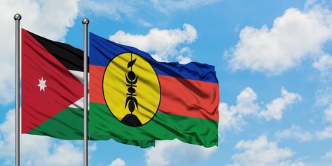 Jordan and New Caledonia flag waving in the wind against white cloudy blue sky together. Diplomacy concept, international relations.