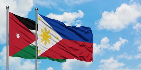 Jordan and Philippines flag waving in the wind against white cloudy blue sky together. Diplomacy concept, international relations.