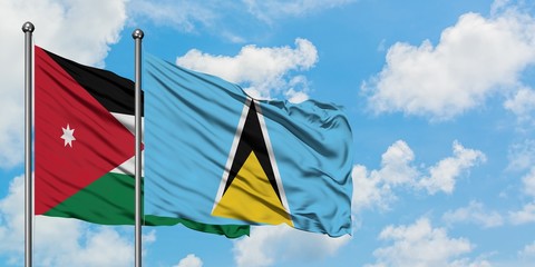Jordan and Saint Lucia flag waving in the wind against white cloudy blue sky together. Diplomacy concept, international relations.