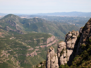 Fototapeta na wymiar Rocky slopes of Montserrat, covered with dense vegetation.