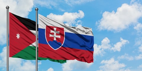 Jordan and Slovakia flag waving in the wind against white cloudy blue sky together. Diplomacy concept, international relations.