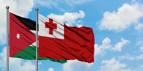 Jordan and Tonga flag waving in the wind against white cloudy blue sky together. Diplomacy concept, international relations.