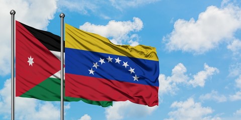 Jordan and Venezuela flag waving in the wind against white cloudy blue sky together. Diplomacy concept, international relations.