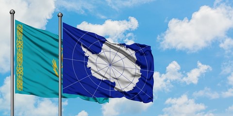 Kazakhstan and Antarctica flag waving in the wind against white cloudy blue sky together. Diplomacy concept, international relations.
