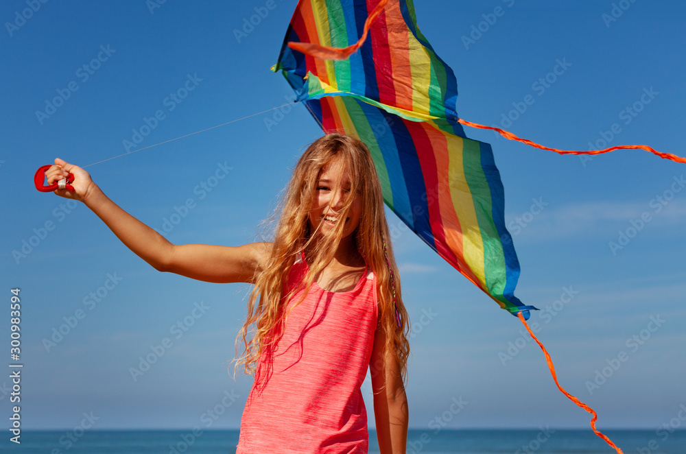 Wall mural happy beautiful carefree girl with color kite