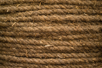 Thick coarse hand-knitted rope of coconut fiber. Natural background