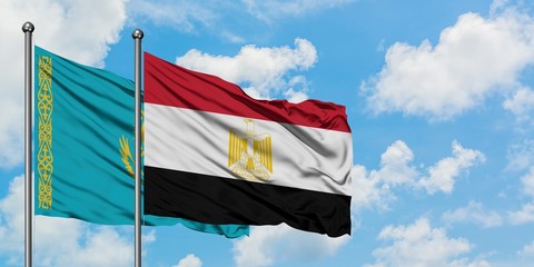 Kazakhstan and Egypt flag waving in the wind against white cloudy blue sky together. Diplomacy concept, international relations.