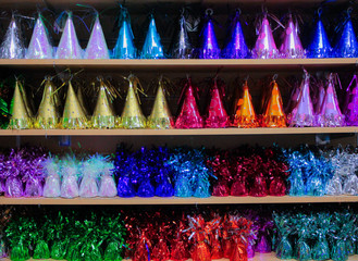 Fototapeta premium Colorful bright heavy weights for balloons, in the form of birthday caps and as a gift for carnival, holiday
