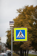 pedestrian sign on the background of autumn trees