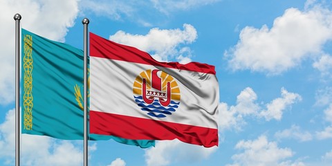 Kazakhstan and French Polynesia flag waving in the wind against white cloudy blue sky together. Diplomacy concept, international relations.