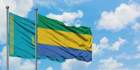 Kazakhstan and Gabon flag waving in the wind against white cloudy blue sky together. Diplomacy concept, international relations.