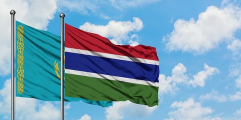 Kazakhstan and Gambia flag waving in the wind against white cloudy blue sky together. Diplomacy concept, international relations.